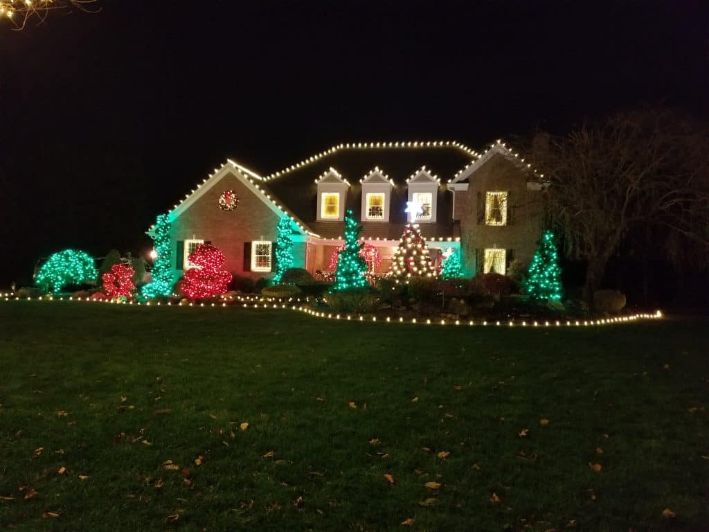 house exterior with red and green holiday lights.